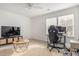 Bright room with natural light, desk, chair, TV, and coffee table at 1180 Trident Maple, Lawrenceville, GA 30045