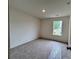 Cozy bedroom with plush carpeting and a bright window overlooking the yard at 1964 Asher Ln # 47, Conyers, GA 30013