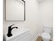 Clean bathroom features a modern sink, a black faucet, and a toilet at 2805 Long Way, Decatur, GA 30032
