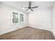 Bedroom with light wood floors, a ceiling fan, and natural light from two windows at 2805 Long Way, Decatur, GA 30032