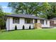View of the landscaped front yard and exterior of a charming home with newly installed siding at 2805 Long Way, Decatur, GA 30032