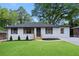 Charming ranch-style home featuring a well-manicured lawn, dark shutters, and a freshly painted exterior at 2805 Long Way, Decatur, GA 30032