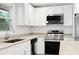 White kitchen features granite countertops, stainless steel appliances, and white subway tile backsplash at 2805 Long Way, Decatur, GA 30032