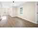 A bright living room with modern light fixture, new hardwood floors, and fresh paint at 2805 Long Way, Decatur, GA 30032