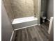 A bathroom with new floors, updated tiling, and shower-tub combination at 50 Ivy St, Porterdale, GA 30014