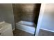 This bathroom features updated tile and a shower-tub combination at 50 Ivy St, Porterdale, GA 30014