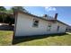 Exterior side shot of a well-maintained home with a carport and nice yard and exterior colors at 50 Ivy St, Porterdale, GA 30014