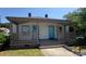 Charming one-story home with a welcoming front porch and light exterior and bright blue doors at 50 Ivy St, Porterdale, GA 30014