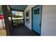 Inviting covered front porch with bright blue front door, great for enjoying the outdoors at 50 Ivy St, Porterdale, GA 30014