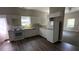 Well-lit kitchen featuring white cabinets, modern appliances, and an adjacent living area at 50 Ivy St, Porterdale, GA 30014