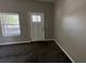 Living room with front door and large window at 50 Ivy St, Porterdale, GA 30014