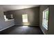 Open floor plan living room featuring new carpeting and plenty of natural light at 50 Ivy St, Porterdale, GA 30014