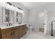 Bathroom with double sink vanity, modern fixtures, and marble tile at 5863 Landers Loop, Fairburn, GA 30213