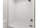 Modern bathtub and shower with sleek black hardware and subway tile at 5863 Landers Loop, Fairburn, GA 30213