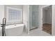 Bathroom featuring modern shower and freestanding tub at 5863 Landers Loop, Fairburn, GA 30213
