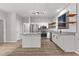 Open concept kitchen with stainless steel appliances and white cabinetry at 5863 Landers Loop, Fairburn, GA 30213