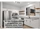 All new designer kitchen with stainless appliances, stone counters, floating shelves & backsplash at 5863 Landers Loop, Fairburn, GA 30213