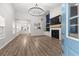 Bright living room featuring high ceilings, modern lighting, and fireplace at 5863 Landers Loop, Fairburn, GA 30213