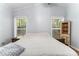 Bright bedroom featuring hardwood floors and natural light from two windows at 103 Campground School Rd, Dallas, GA 30157