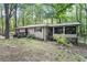 A lovely home with a screened in porch on a large lot surrounded by mature trees at 103 Campground School Rd, Dallas, GA 30157