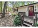 Charming red door and wood porch railings add to the cozy curb appeal at 103 Campground School Rd, Dallas, GA 30157