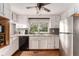 Bright kitchen with white cabinets, stainless steel appliances, and a window overlooking the backyard at 103 Campground School Rd, Dallas, GA 30157