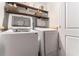Functional laundry area with washer, dryer, and shelving for storage at 103 Campground School Rd, Dallas, GA 30157