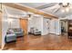 Open living room with hardwood floors, gray sofas, and natural wood accents at 103 Campground School Rd, Dallas, GA 30157