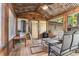 Spacious screened porch with rustic charm, complete with wooden floors and comfortable seating at 103 Campground School Rd, Dallas, GA 30157