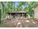 Rustic shed surrounded by lush greenery, adding a touch of charm to the property at 103 Campground School Rd, Dallas, GA 30157