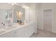 Bathroom features a dual sink vanity with marble countertop, stylish decor, and a large closet at 115 Maplewood Ln, Conyers, GA 30094