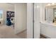 Bathroom with a white single sink vanity and a view to the bedroom at 115 Maplewood Ln, Conyers, GA 30094