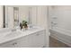 Bright bathroom featuring a double sink vanity, modern fixtures, and a shower-tub combo at 115 Maplewood Ln, Conyers, GA 30094
