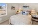Bright bedroom featuring a comfortable bed with stylish pillows and bedside tables, with a view to the outdoors at 115 Maplewood Ln, Conyers, GA 30094