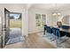 Bright dining room featuring a modern chandelier, stylish furniture, and ample natural light at 115 Maplewood Ln, Conyers, GA 30094
