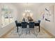 Elegant dining room with modern décor, stylish seating, and large windows at 115 Maplewood Ln, Conyers, GA 30094