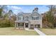 Beautiful two-story home with mixed siding, a covered front porch, and lush green lawn at 115 Maplewood Ln, Conyers, GA 30094