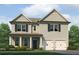 Charming two-story home featuring a symmetrical facade, double garage, and landscaped front yard at 115 Maplewood Ln, Conyers, GA 30094