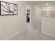 Hallway with carpet and walls decorated with modern art leading to the bedroom at 115 Maplewood Ln, Conyers, GA 30094
