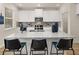 Bright, modern kitchen featuring an island with bar seating, stainless appliances, and ample cabinet space at 115 Maplewood Ln, Conyers, GA 30094