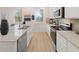 Bright kitchen boasts granite counters, stainless appliances, and white cabinetry at 115 Maplewood Ln, Conyers, GA 30094