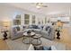 Bright, open living room with large sectional sofa and plenty of natural light at 115 Maplewood Ln, Conyers, GA 30094