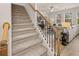 Carpeted staircase with wooden handrail leading to the living room at 115 Maplewood Ln, Conyers, GA 30094