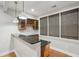 Cozy bar area with dark countertops, wood cabinets, and pendant lighting at 1215 Comet View Se Trl, Smyrna, GA 30082