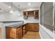 Home bar featuring wood cabinets, pendant lighting, and dark granite counters at 1215 Comet View Se Trl, Smyrna, GA 30082