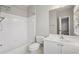 Bright bathroom showcasing a shower-tub combo, vanity with sink, and large mirror at 1215 Comet View Se Trl, Smyrna, GA 30082