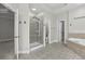 Primary bathroom with a glass enclosed shower, soaking tub, and linen closet at 1215 Comet View Se Trl, Smyrna, GA 30082