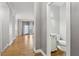 Hallway leads to a half bathroom with a modern toilet and sink at 1215 Comet View Se Trl, Smyrna, GA 30082