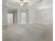 An airy bedroom featuring a ceiling fan, tray ceiling, neutral paint, and access to an en-suite bathroom at 1215 Comet View Se Trl, Smyrna, GA 30082
