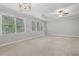 Neutral bedroom offering a ceiling fan, tray ceiling, and large windows at 1215 Comet View Se Trl, Smyrna, GA 30082